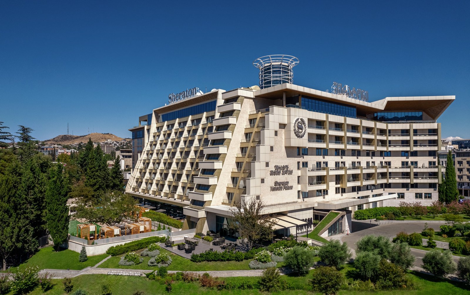 Sheraton Grand Tbilisi Metechi Palace hotel exterior after renovation with surrounding city view